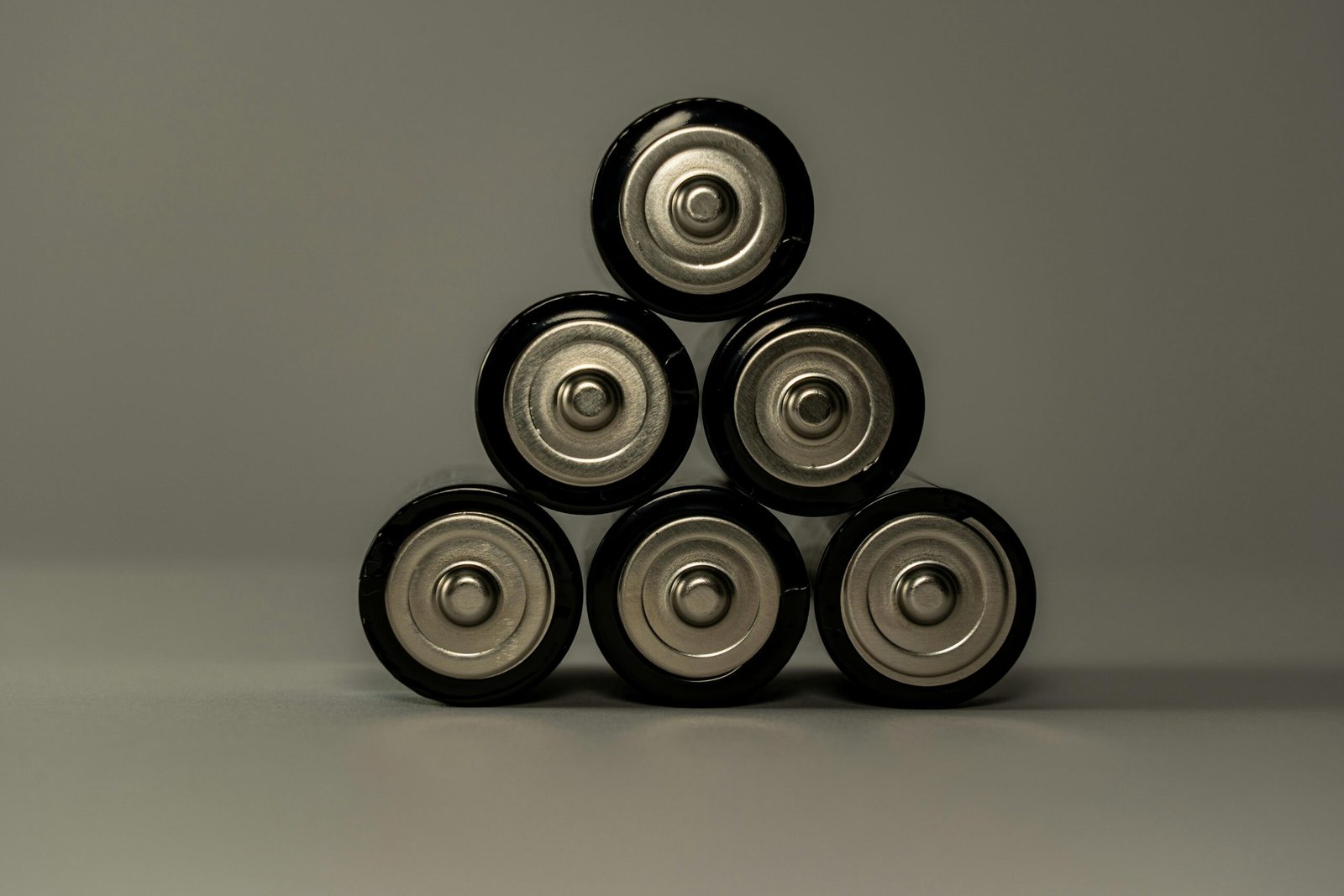 Metallic AA batteries stacked in a pyramid shape, symbolizing power and energy storage.